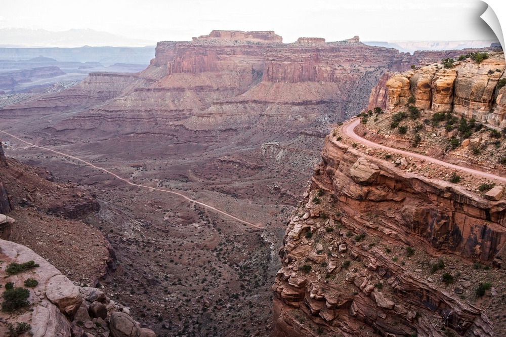 View of the rocky desert landscape with mesas in the distance, seen from Shafer Trail in Canyonlands National Park, Moab, ...