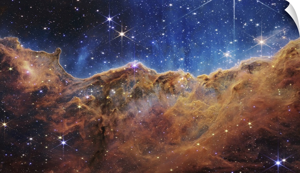 What looks much like craggy mountains on a moonlit evening is actually the edge of a nearby, young, star-forming region NG...