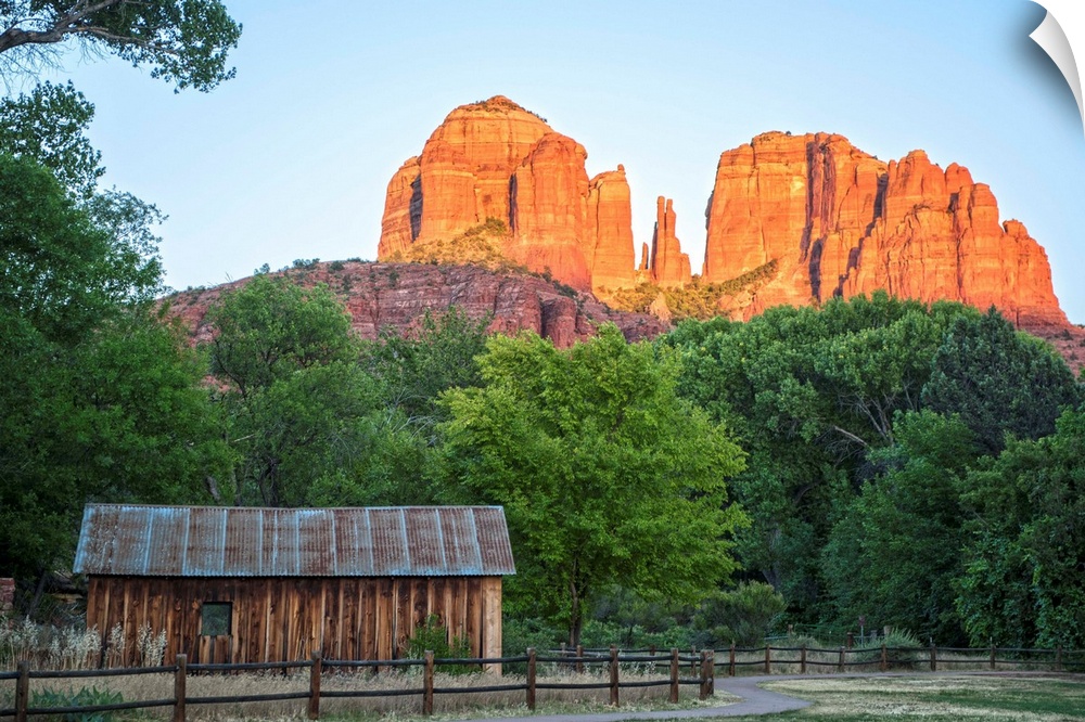 Landscape photograph of Cathedral Rock with a rustic wooden structure in the foreground.