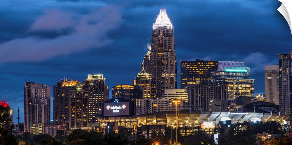 A horizontal image of the Charlotte, North Carolina city skyline at night.