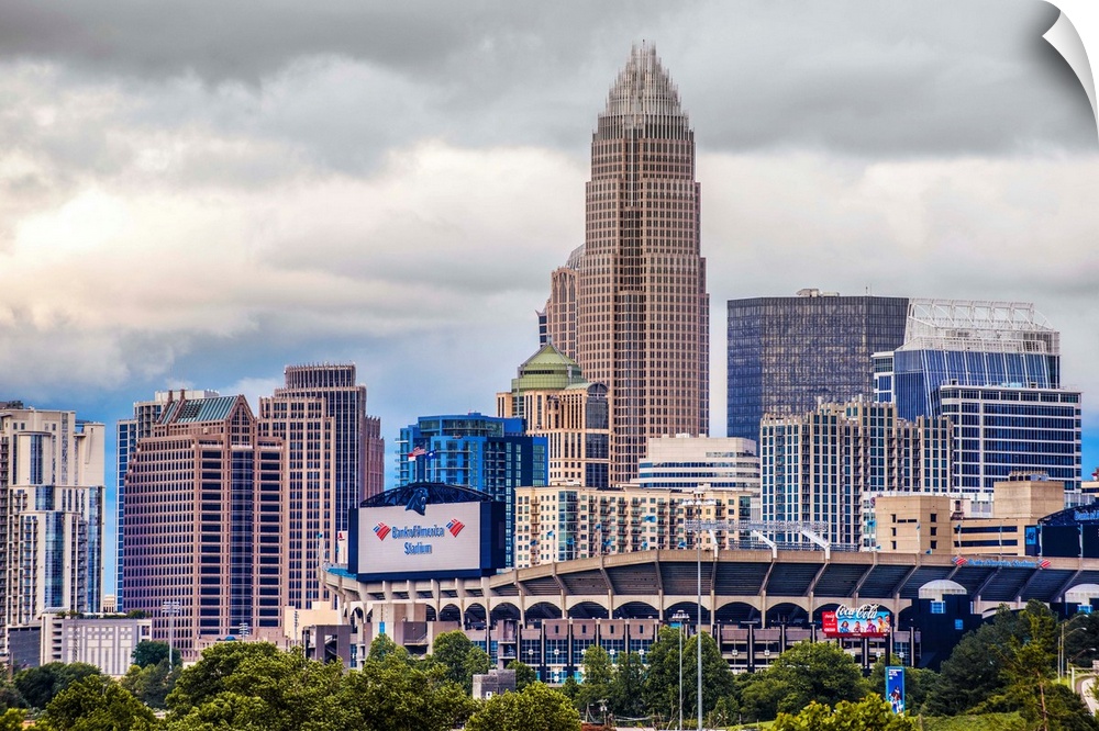Horizontal image of the city of Charlotte, North Carolina with a cloudy sky.