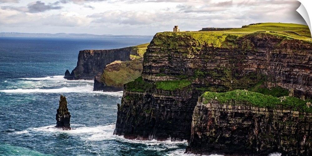 Panoramic photograph of the Cliffs of Moher with O'Brien's Tower seen in the distance, marking the highest point of the Cl...