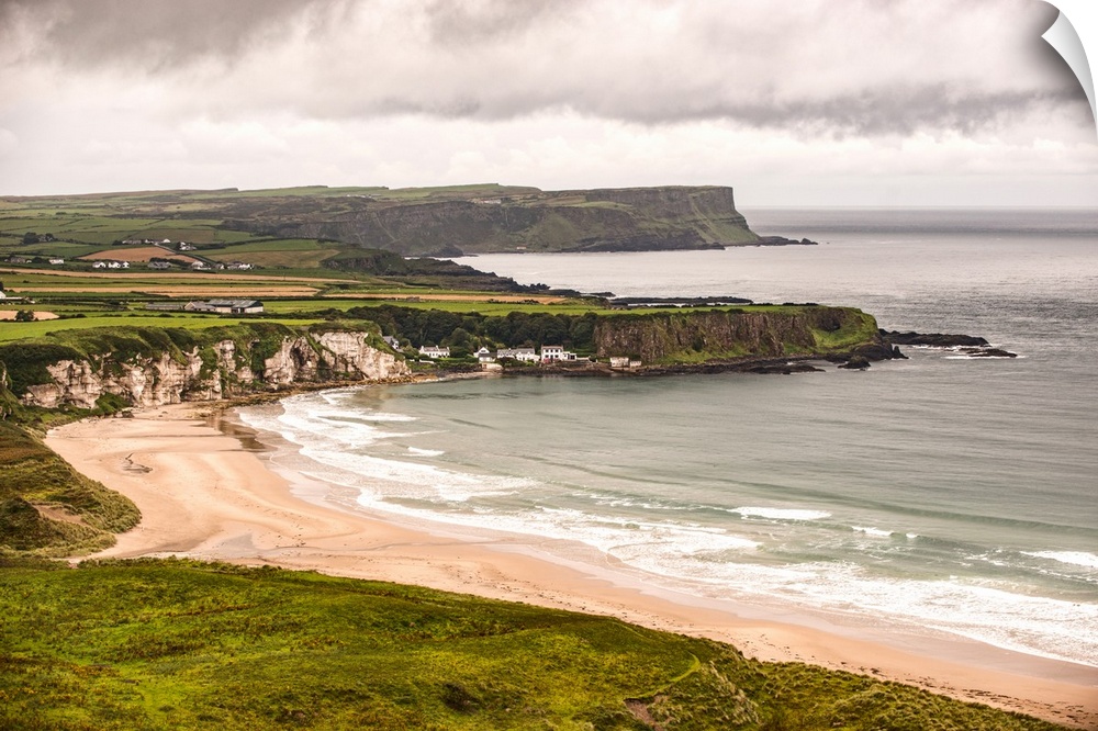Landscape photograph of an Irish coastline with dramatic clouds above, County Antrim, Ireland.