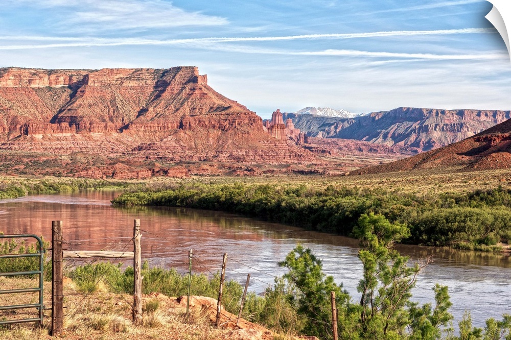 The Colorado river running past the sandstone cliffs of the Red Rock Canyon, Arches National Park, Utah.