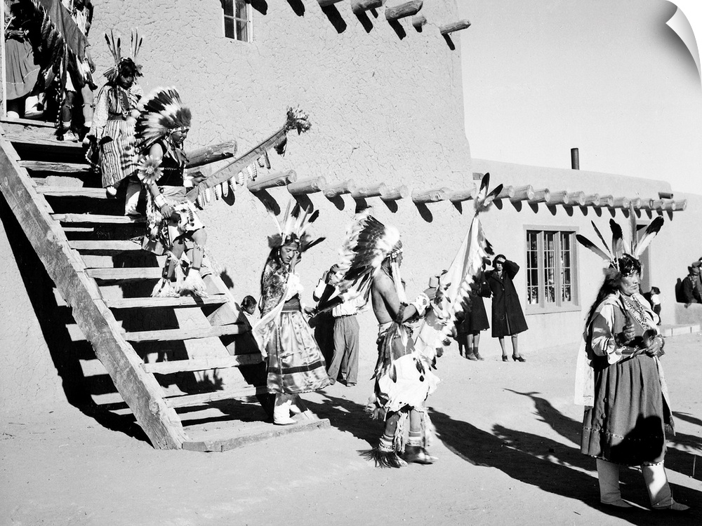 Dance, San Ildefonso Pueblo, New Mexico,Indians in headdress, male and female, descending stairs.