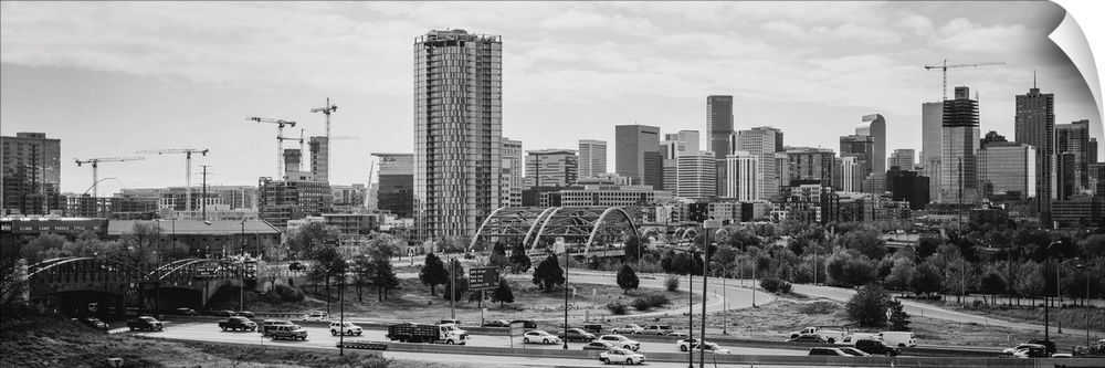 Photograph of the Denver, Colorado skyline with cloudy skies above.