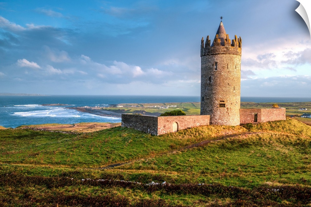 Photograph of Doonagore Castle in Doolin in County Clare, Ireland, with a beautiful sunset.