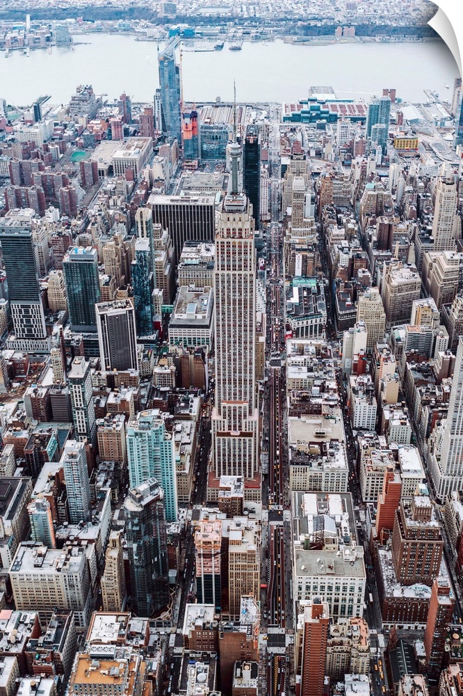 Aerial view of the Empire State Building surrounded by skyscrapers in New York City.