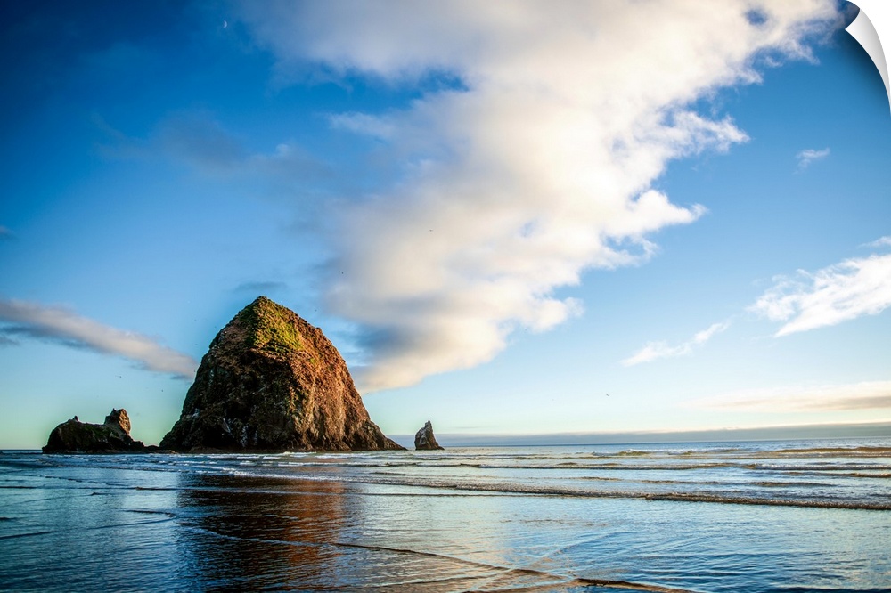 Panoramic photograph of Haystack Rock at golden hour, just before sunset, Cannon Beach, Oregon.