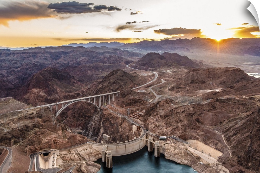 View from above of the Hoover Dam and Lake Mead, with the Mike O'Callaghan-Pat Tillman Memorial Bridge, at sunset with clo...