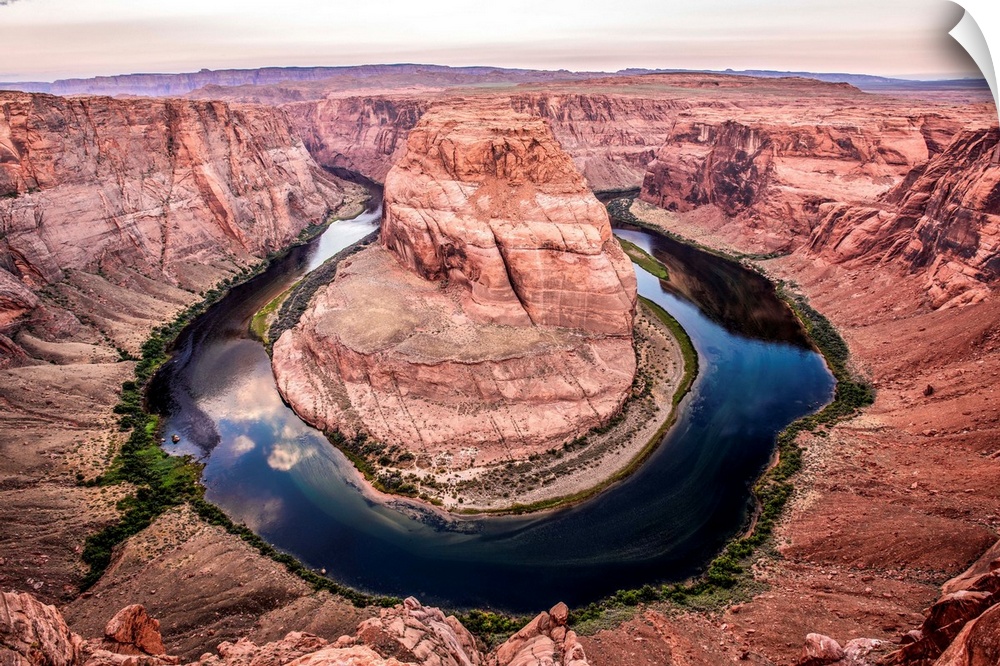 Landscape photograph of Horseshoe Bend in Arizona with the blue and green Colorado River reflecting the sky above.