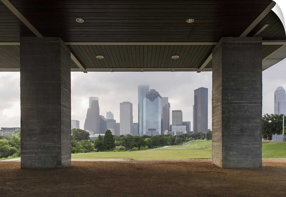 Photograph of the Houston Skyline surrounded by clouds viewed from Eleanor Tinsley Park.