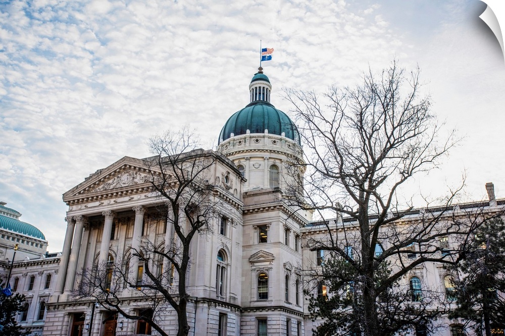 Photo of the Indiana State House under puffy clouds.
