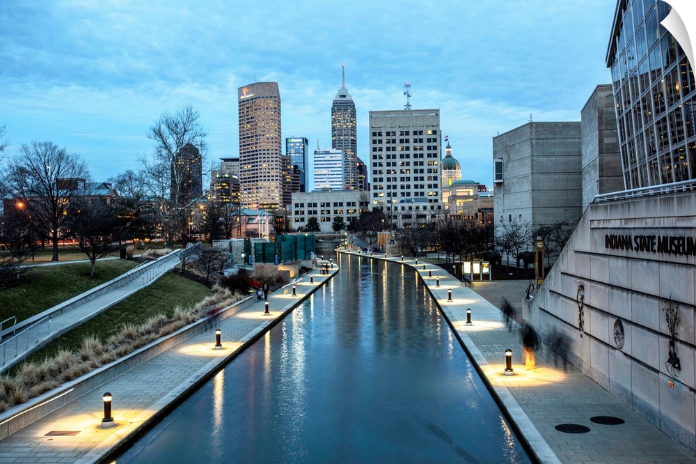 Photo of the Indianapolis city skyline reflecting onto the Indiana Central Canal.