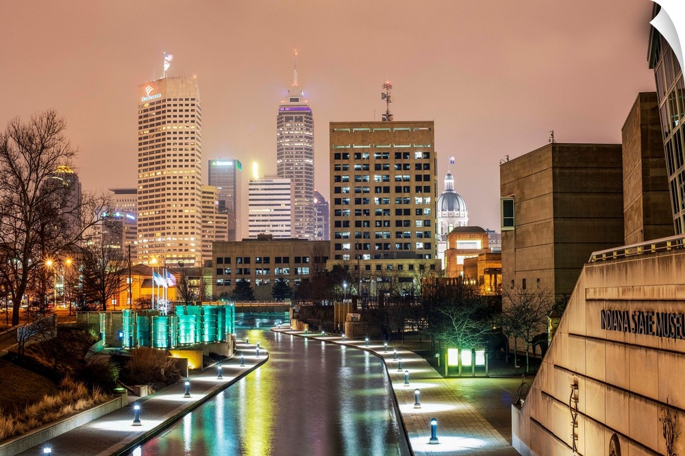 Photo of the Indianapolis city skyline at night reflecting onto the Indiana Central Canal.