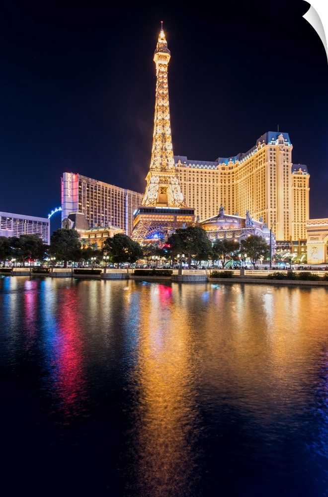Photograph of the Las Vegas strip lit up at night and reflecting into the water.