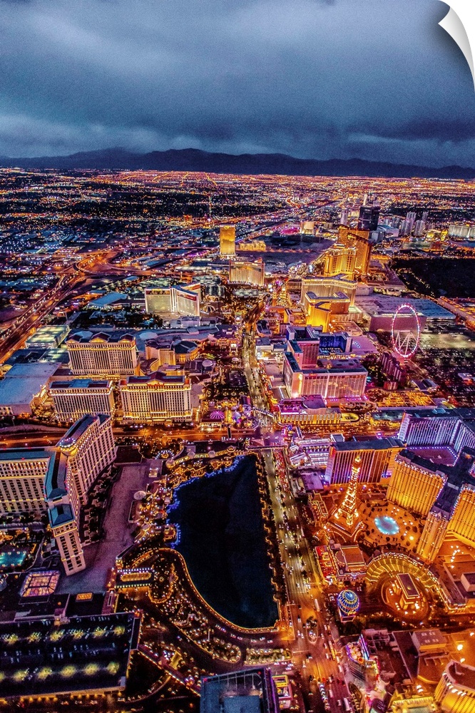Aerial view of the Las Vegas Strip illuminated in the early evening with cloudy skies.