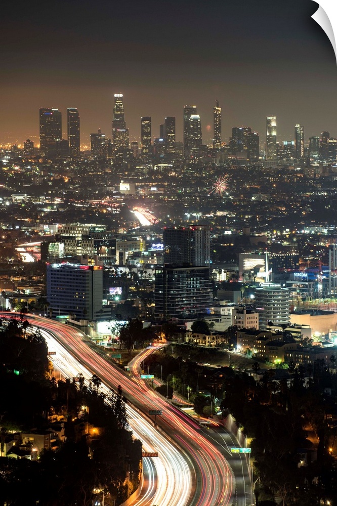 Aerial view photograph of Los Angeles, California with a hazy skyline at night.
