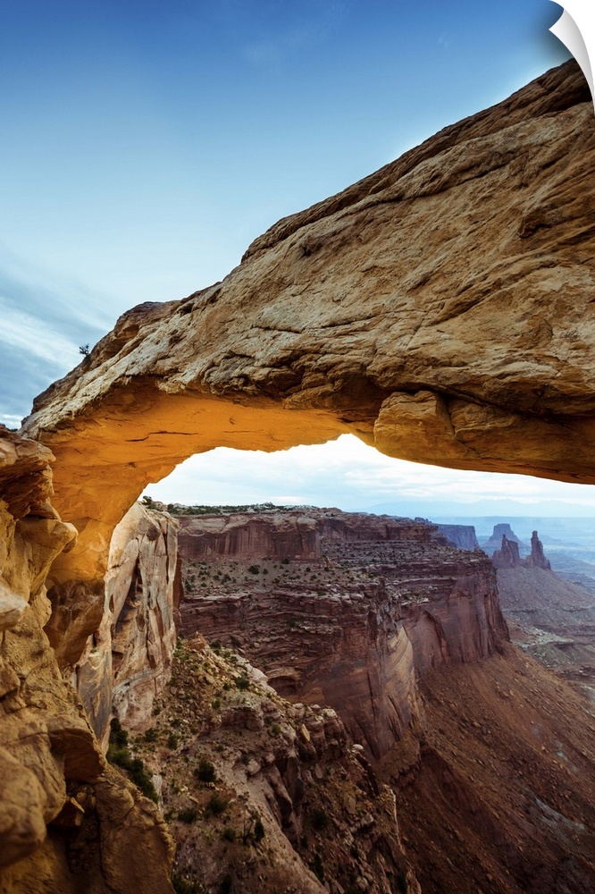 Photograph of the Mesa Arch with canyons in the background in Arches National Park, Utah.