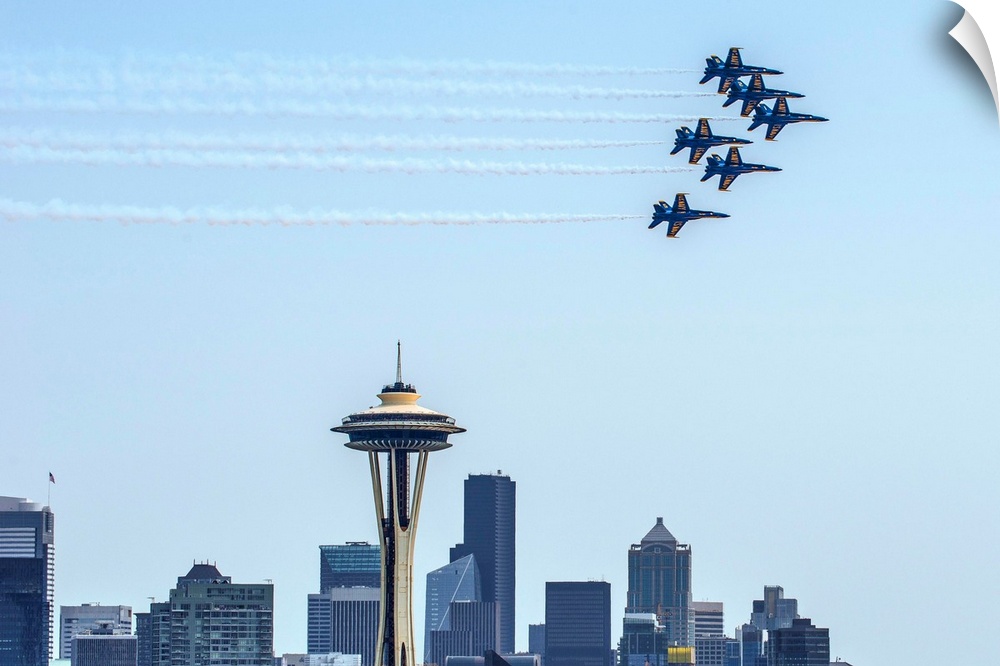 Photograph of 6 Navy jets flying over the Seattle skyline with the Space Needle in the center.