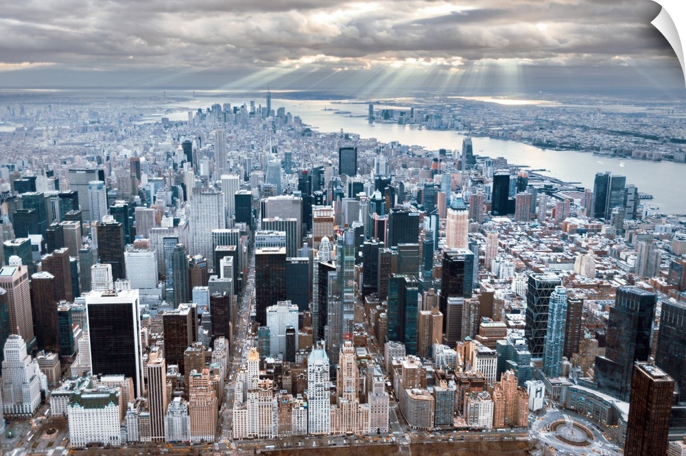 Aerial view of the skyscrapers in New York City, under a cloudy sky.