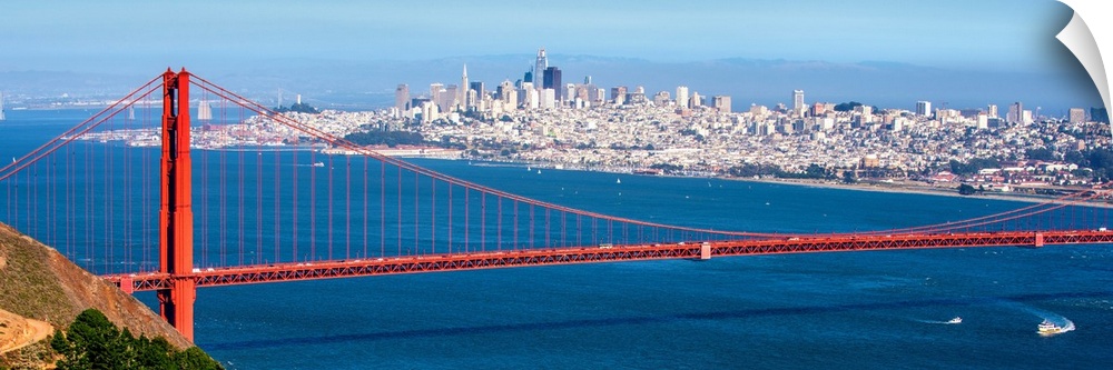 Panoramic photograph of the Golden Gate Bridge with San Francisco's skyscrapers in the background.