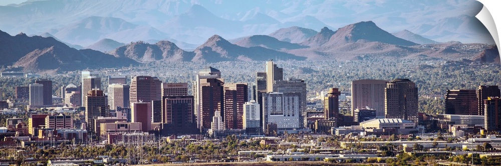 Panoramic photograph of the Phoenix, Arizona skyline with hazy desert mountains in the background.