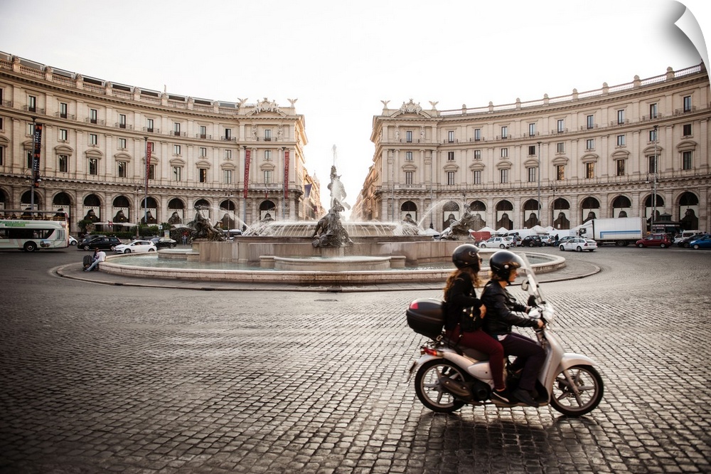 Photograph of the Piazza della Repubblica with the Fountain Of The Naiads and a couple on a motorbike in the foreground, R...
