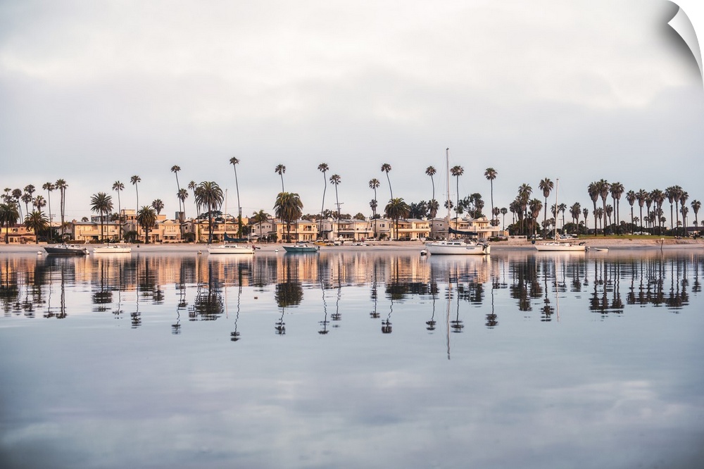 Photograph of beach houses, palm trees, and boats on the San Diego coast reflecting into the water.