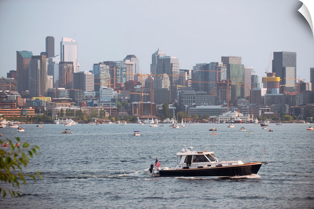 A boat passes by with Seattle's city skyline in the background. View from Lake Union, Washington.