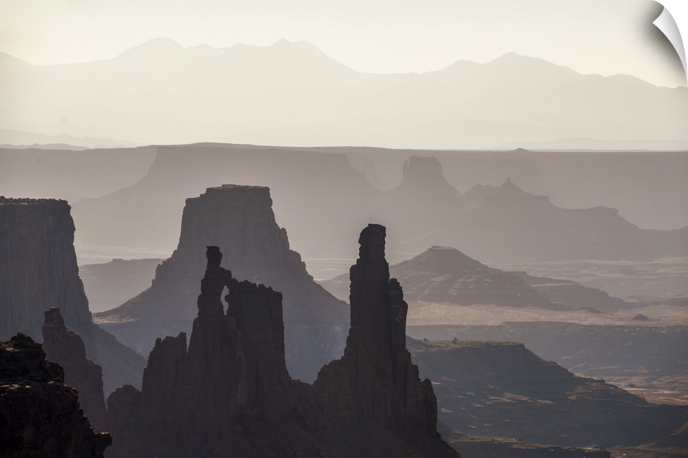 Hazy morning light gives the eroded rock structures a soft blue hue in Canyonlands National Park, Moab, Utah.