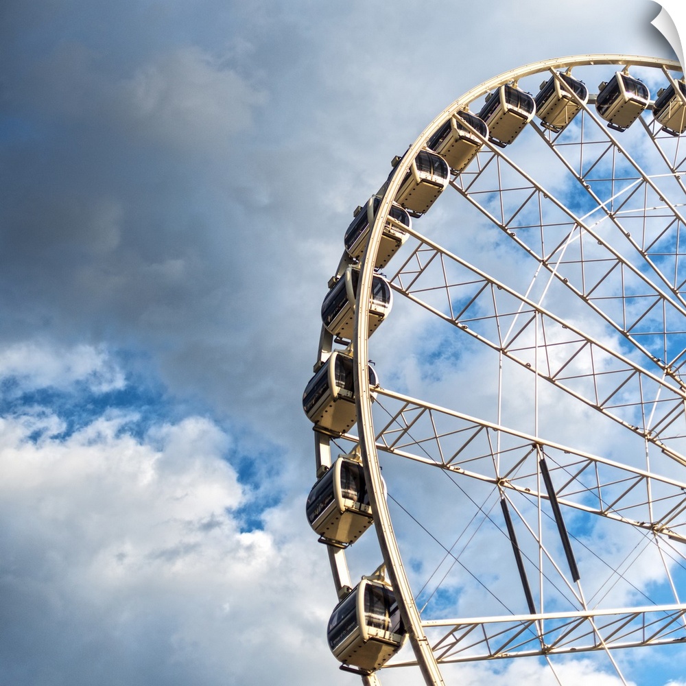 The gondolas of SkyView Atlanta Ferris Wheel, a 20-story wheel, against a backdrop of clouds over Centennial Park, Atlanta...