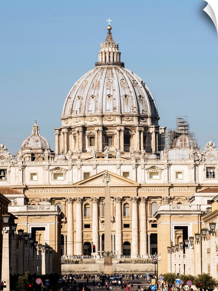Photograph of St. Peter's Basilica in Vatican City with the sun shining on it.