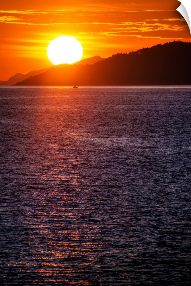 The sun sets on Burrard Inlet near Vancouver in British Columbia, Canada.
