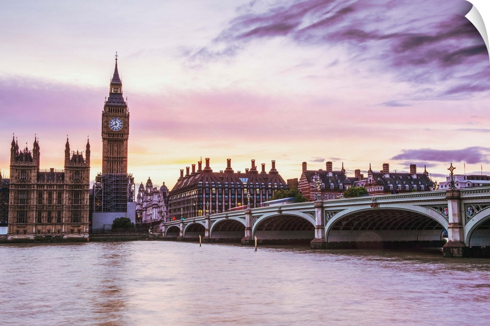 Photograph of Big Ben and the Westminster Bridge with a pink and purple sunset.