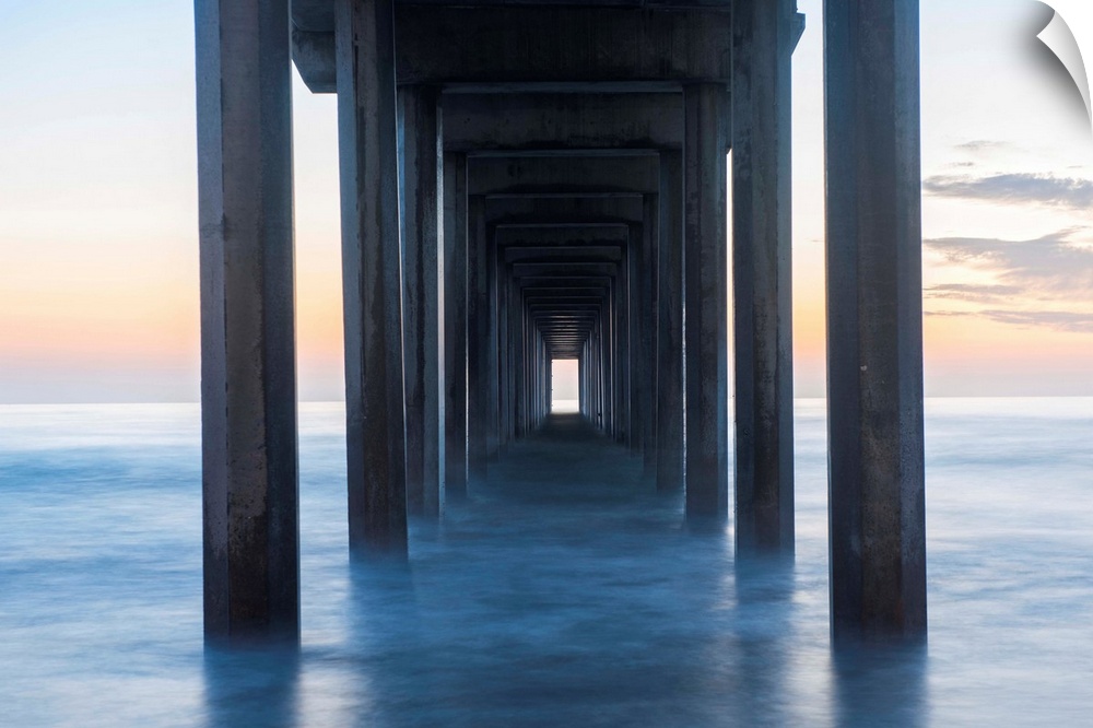 Photograph underneath the Scripps Pier at sunset.