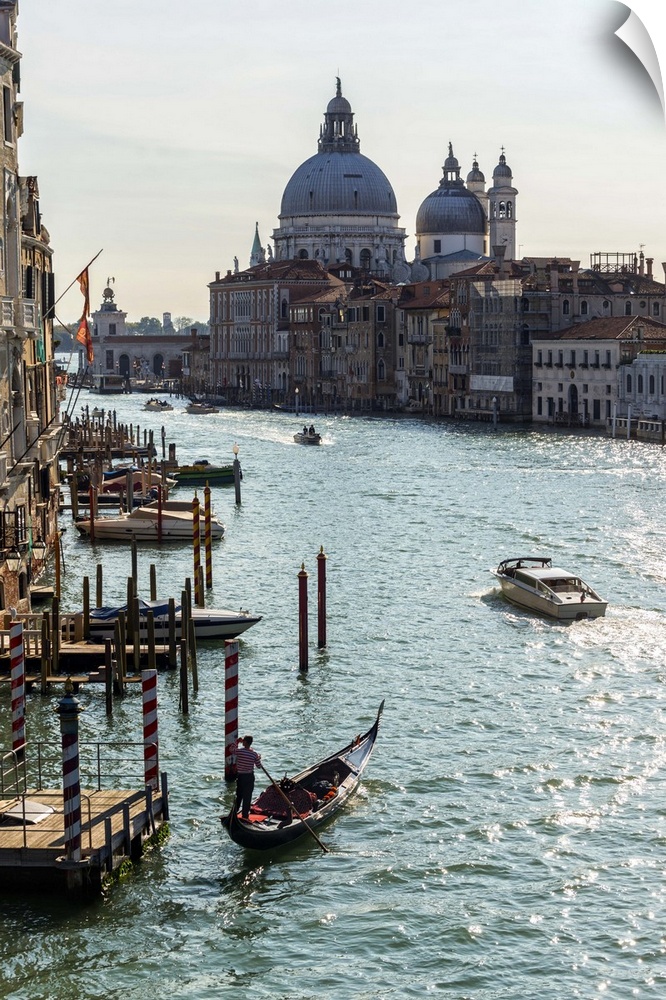 Landscape photograph of gondolas and boats on the Grand Canal with Santa Maria della Salute in the background.