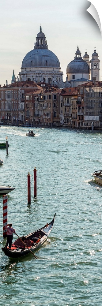 Panoramic photograph of gondolas and boats on the Grand Canal with Santa Maria della Salute in the background.