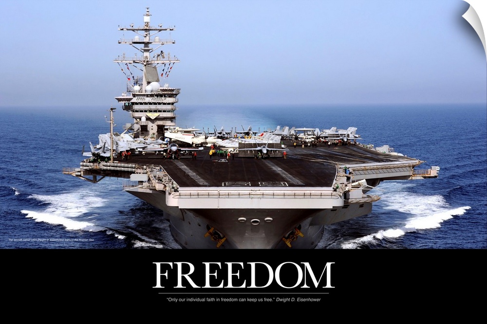 An immense photograph taken of a US navy ship in the open ocean with the word "Freedom" just below it.