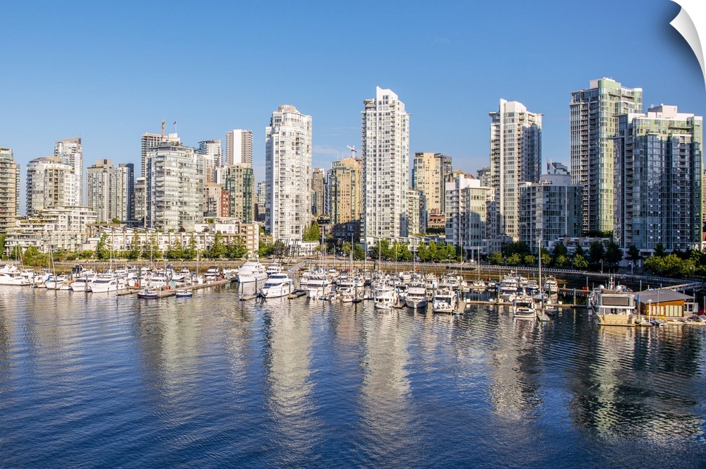 Photograph of part of the Vancouver, British Columbia skyline with False Creek Harbor and boats in the foreground.