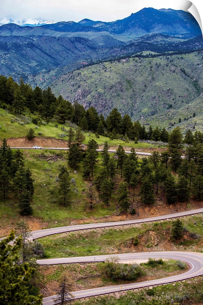 Photo of a winding road below a mountain in Colorado.
