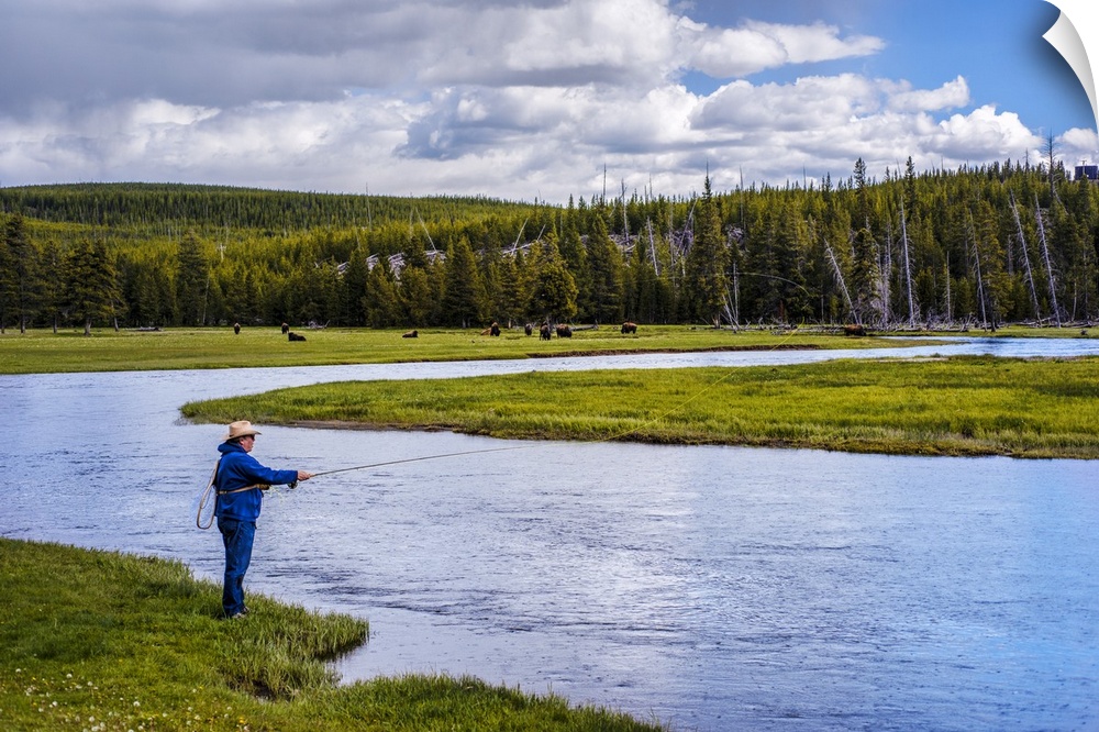 Person fishing along a river at Yellowstone National Park.