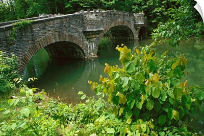 A stone bridge crosses the headwaters of the Susquehanna River, New York