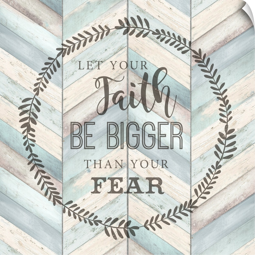 "Let your faith Be Bigger Than Your Fear" surround by a wreath on a chevron wood background.