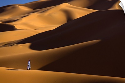 Berber Man Walking In The Erg Chebbi Sand Sea, Sahara Desert, Morocco
