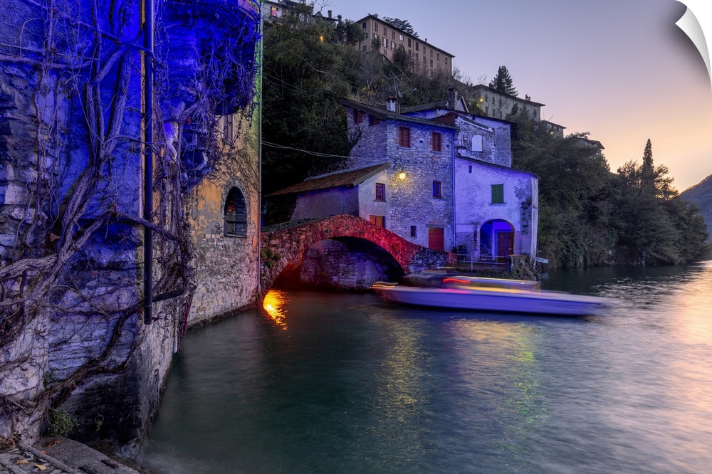 Boat in motion under the illuminated Nesso bridge, Lake Como, Lombardy, Italian Lakes, Italy, Europe