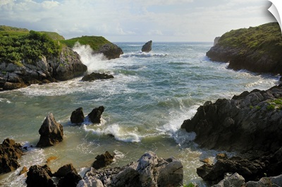 Buelna beach and karst limestone El Picon rock pillar, Asturias, Spain