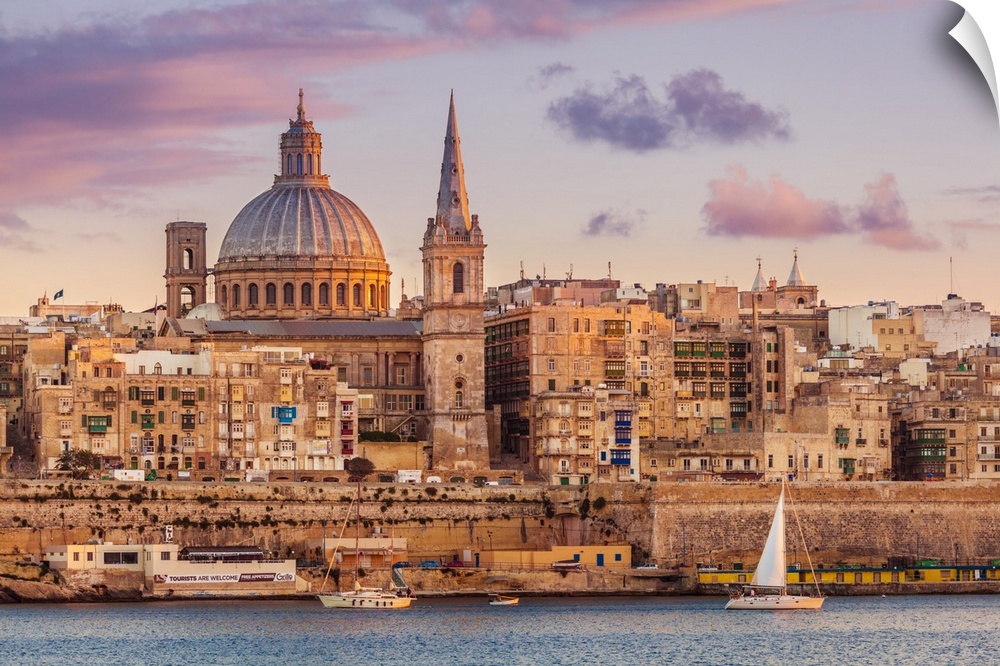 Valletta skyline at sunset with the Carmelite Church dome and St. Pauls Anglican Cathedral, Valletta, Malta, Mediterranean...