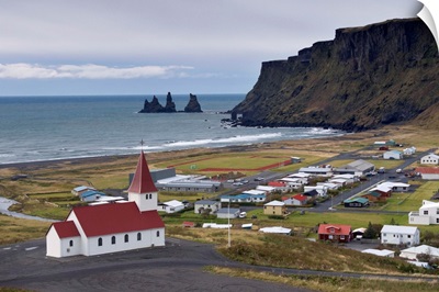 Church, village of Vik and Reynisdrangar sea stacks in the distance, Iceland