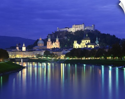 City and castle at night from the river, Salzburg, Austria